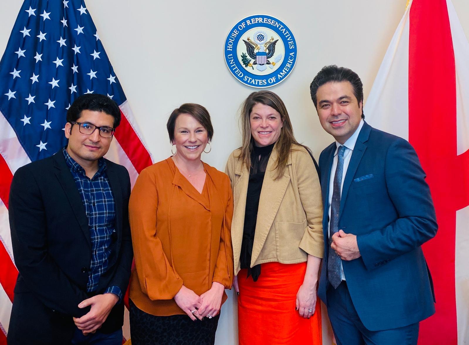 SGE speaker presenting at podium with blue backdrop